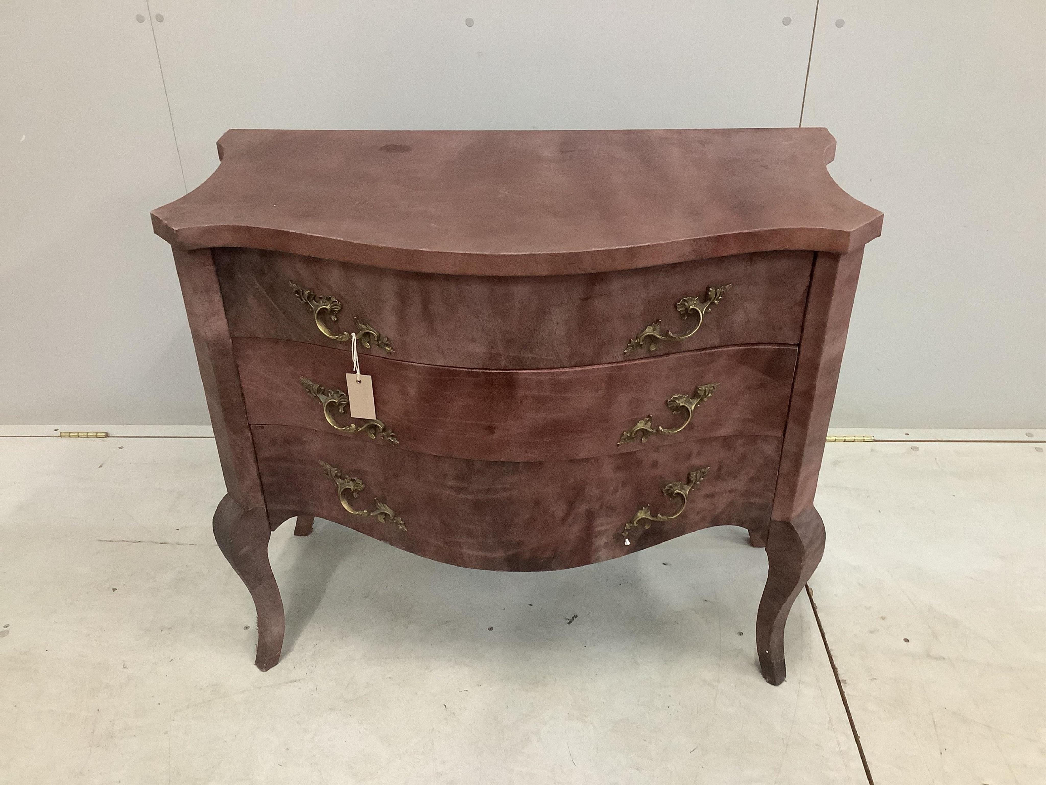 A Continental serpentine three drawer commode with simulated marble covering, width 91cm, height 81cm. Condition - fair condition